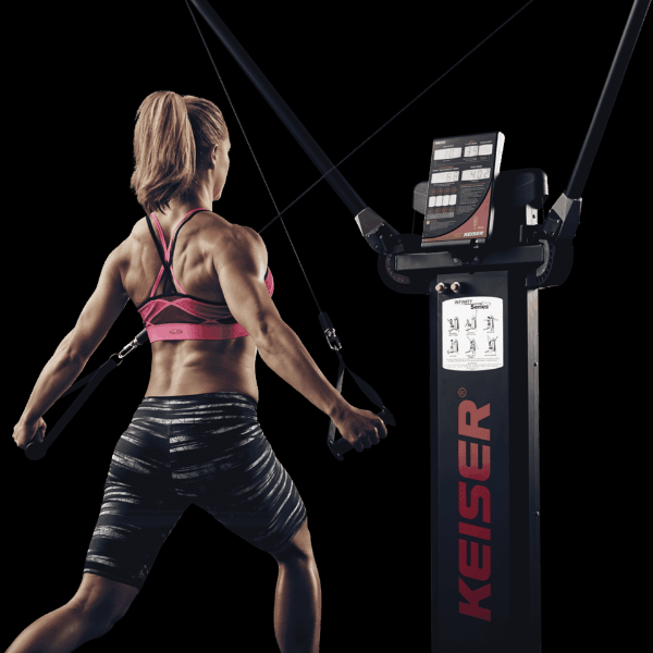 Female using a specialized fitness weight trainer to work out her arms and back.